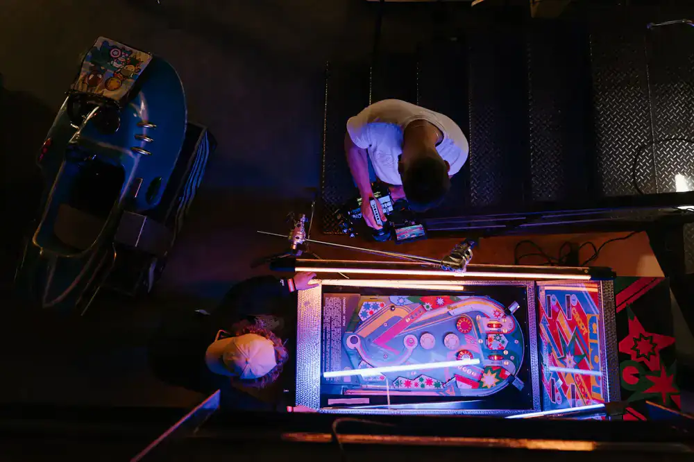 Row of glowing pinball machines