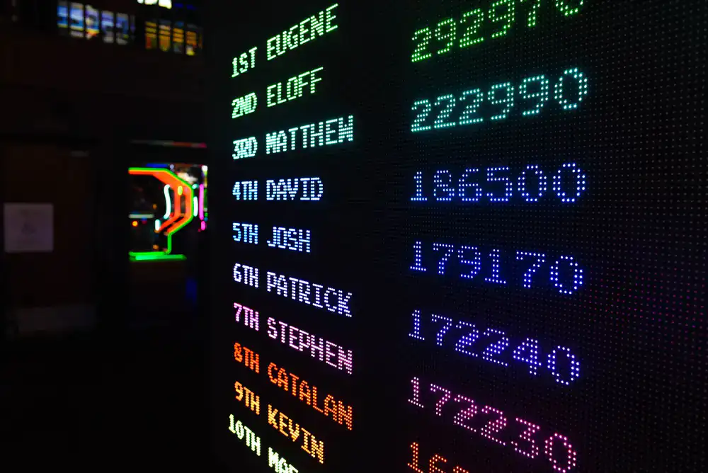 Glowing arcade machines highlighting high score screens